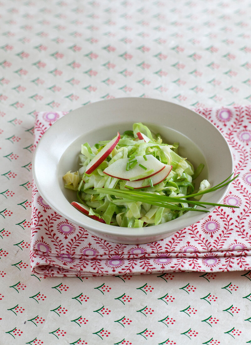 Coleslaw with apple in serving dish