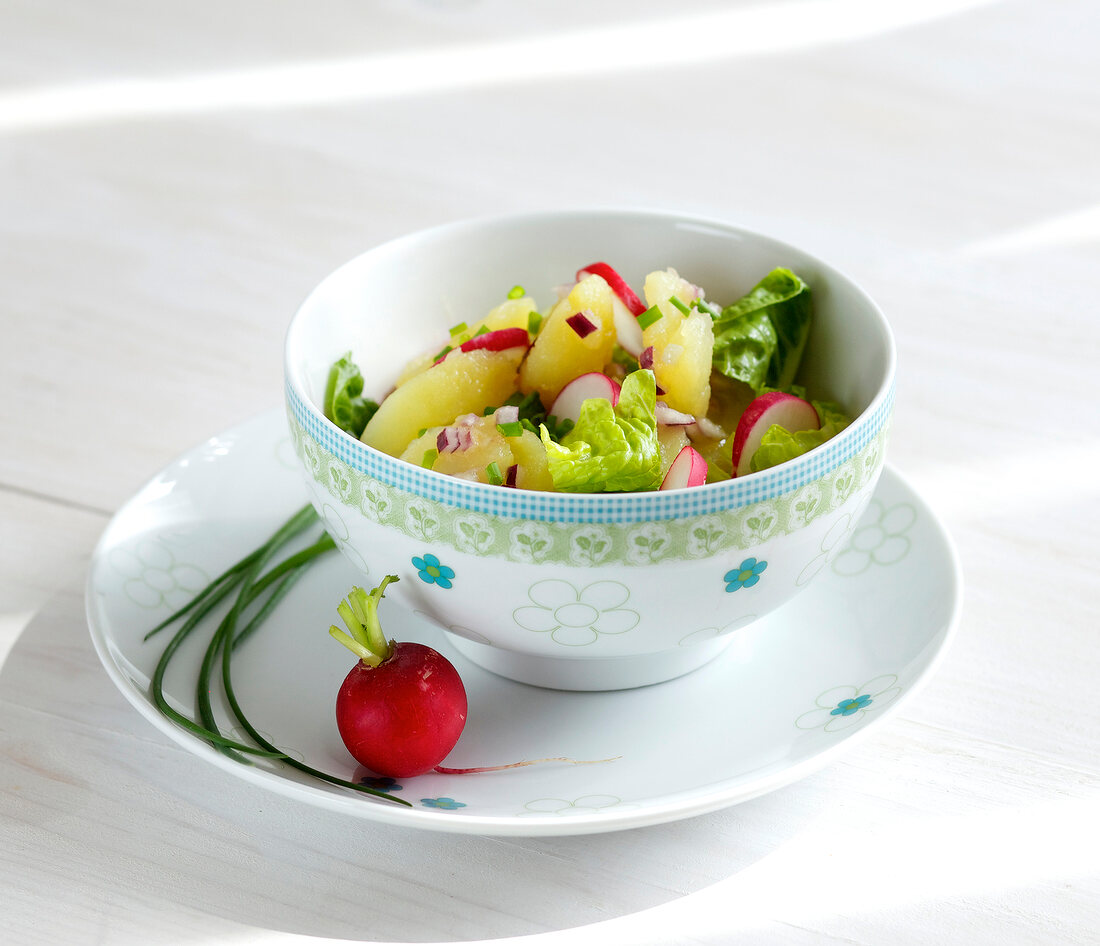 Potato salad with radishes in bowl