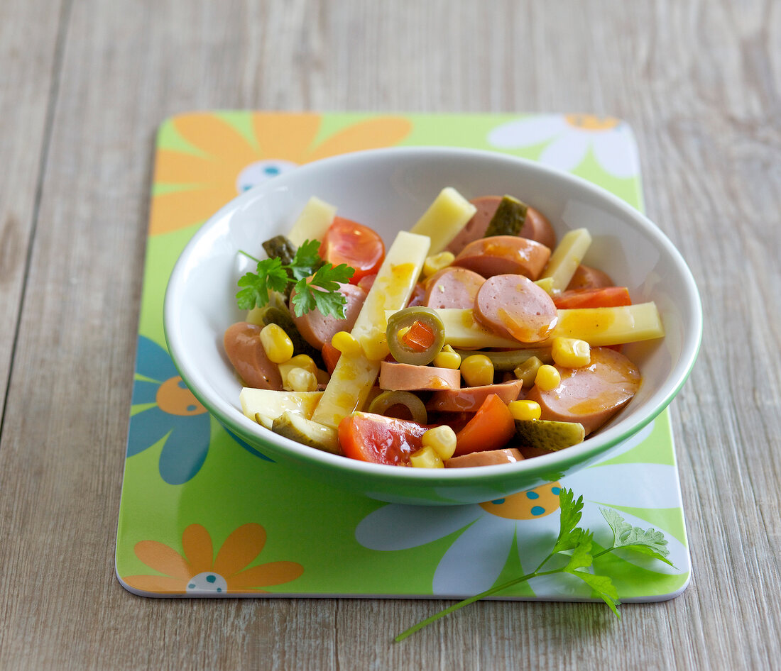 Tomatoes and sausage salad in bowl