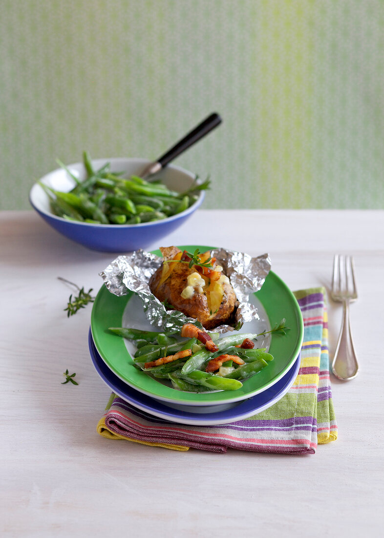 Baked potato with bacon beans on plate