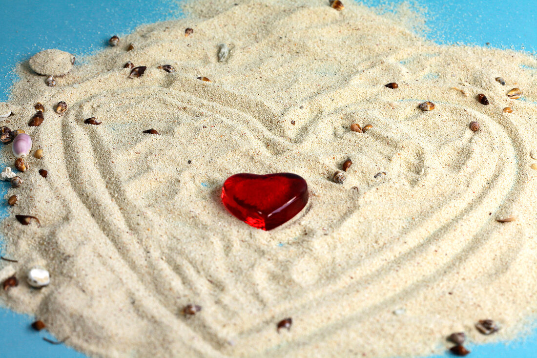 Heart shaped stone in sand