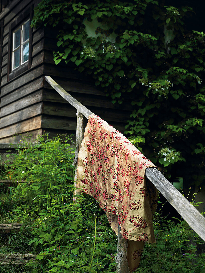 Piece of cloth hanging on wooden railing