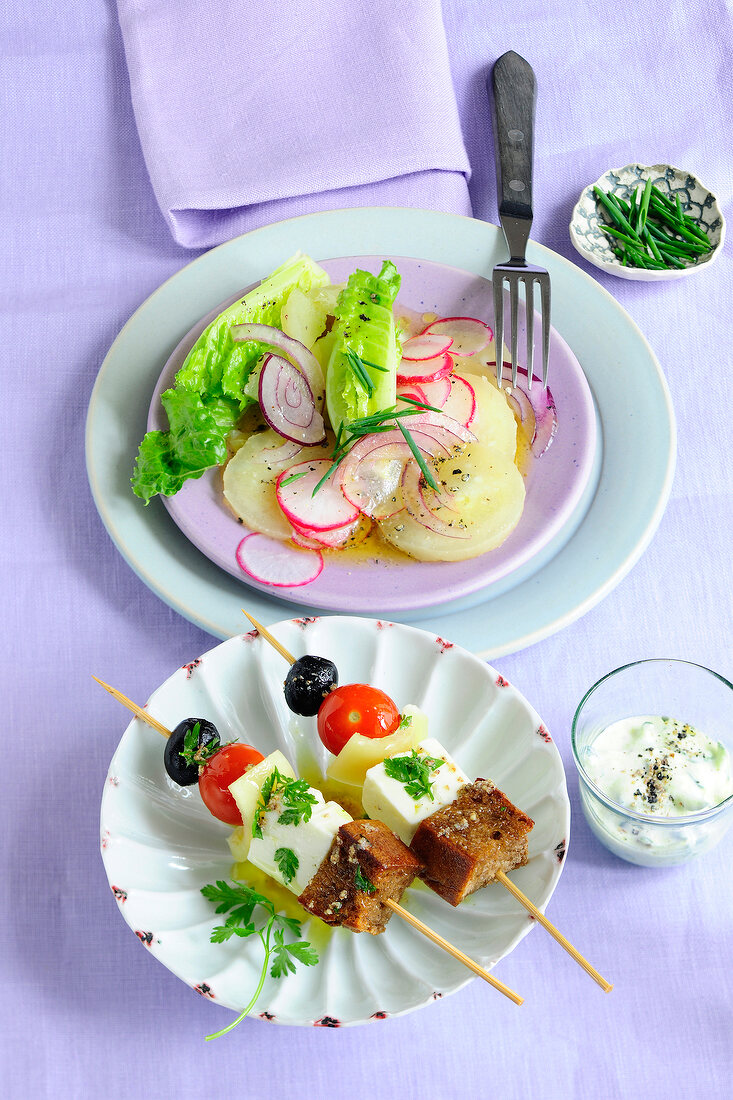 Feta skewers with tzatziki on plate