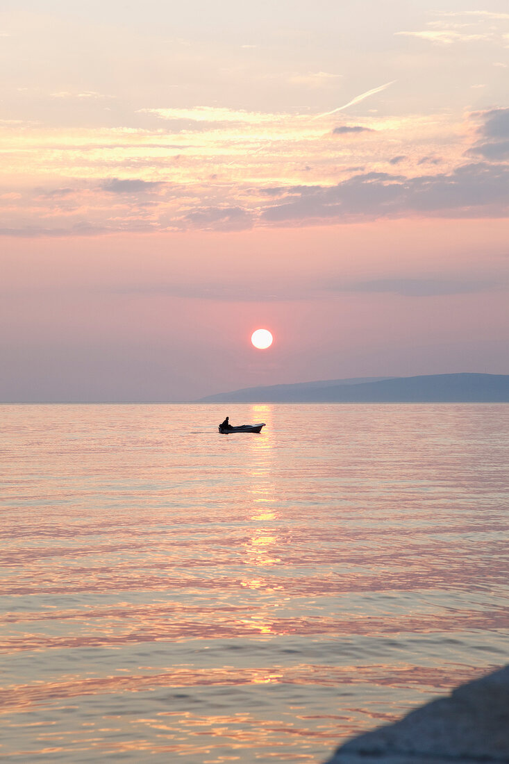 View of sunset and boat in sea, Gradac, Croatia