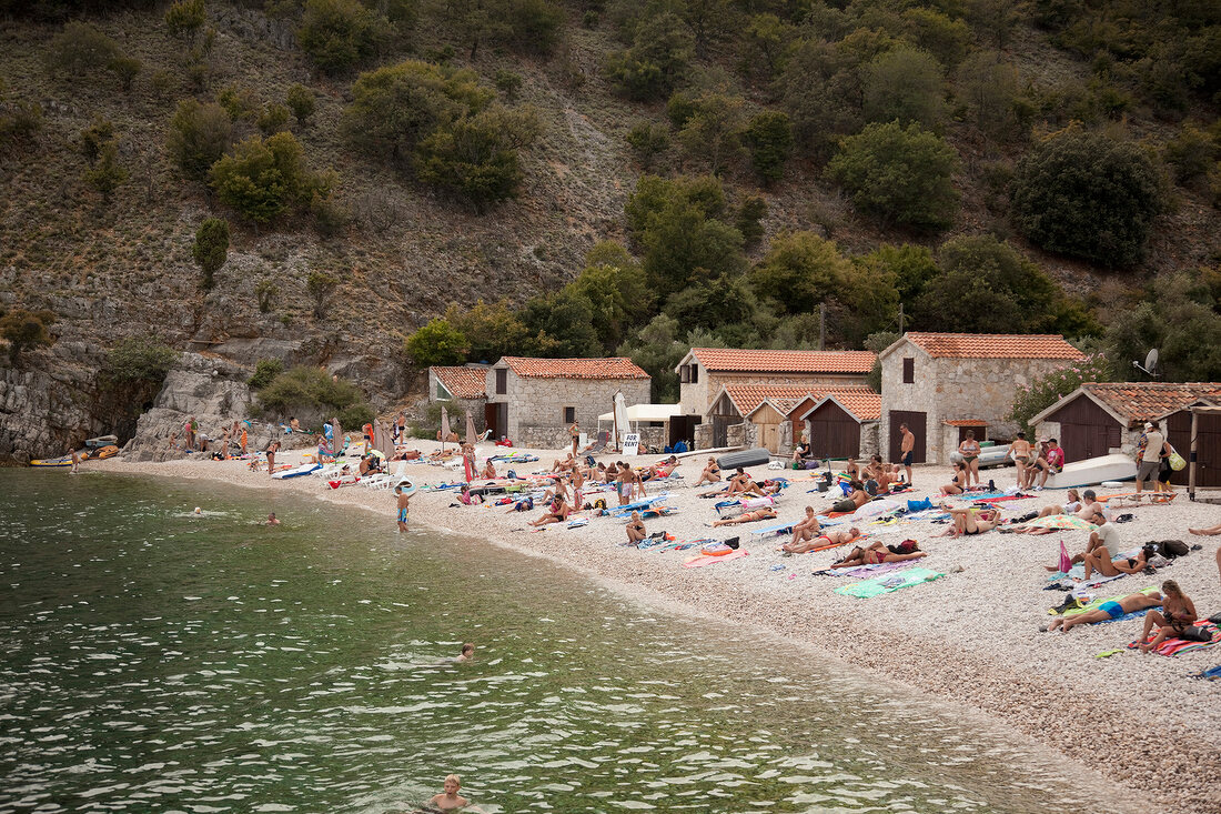 Tourists on beach at Kvarner bay, Croatia