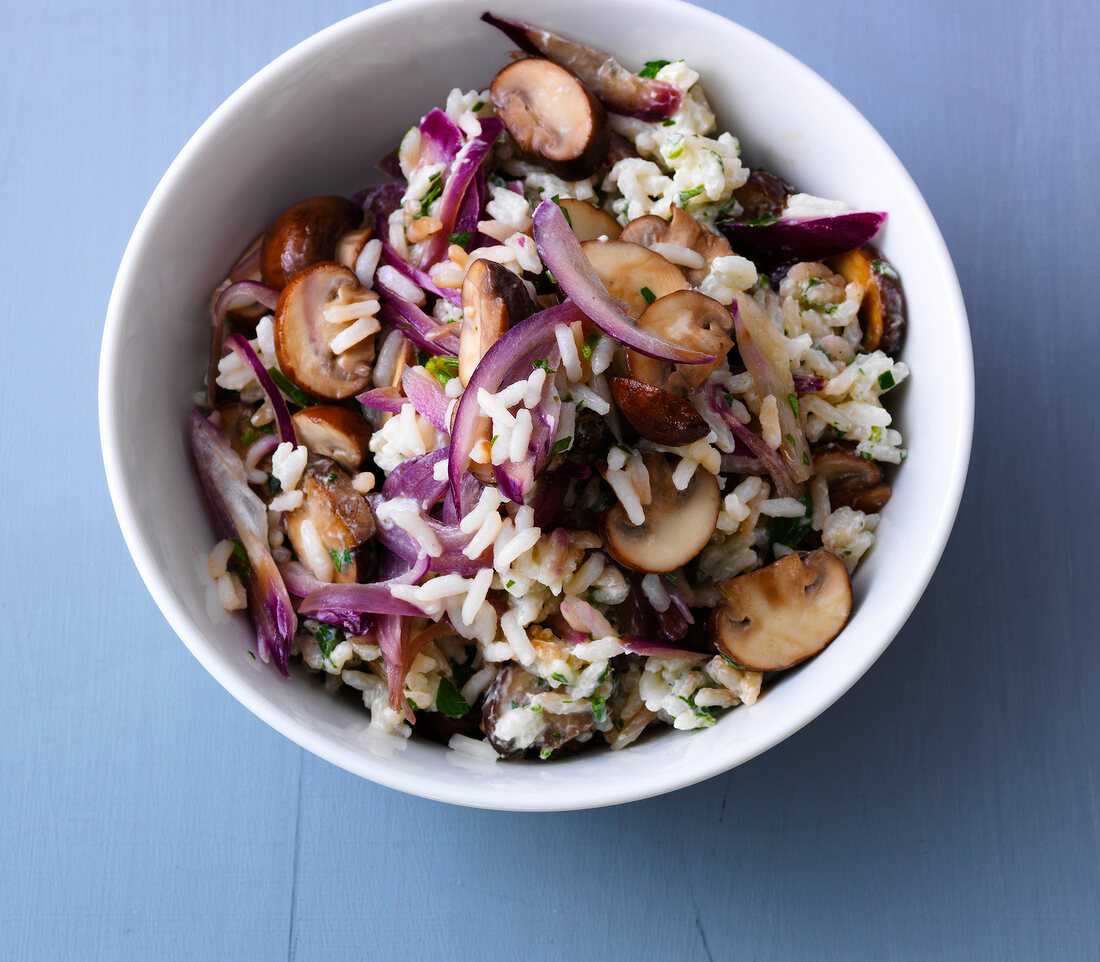 Rice salad with mushrooms in bowl