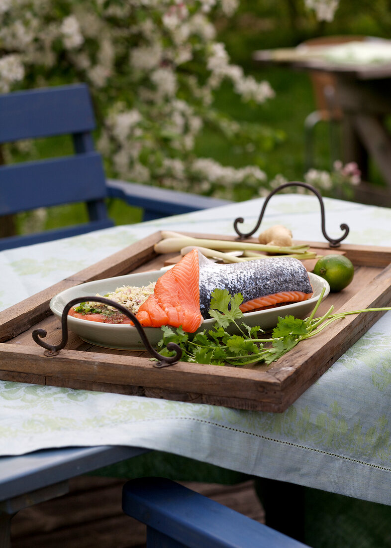 Salmon fillet in tray on wooden board