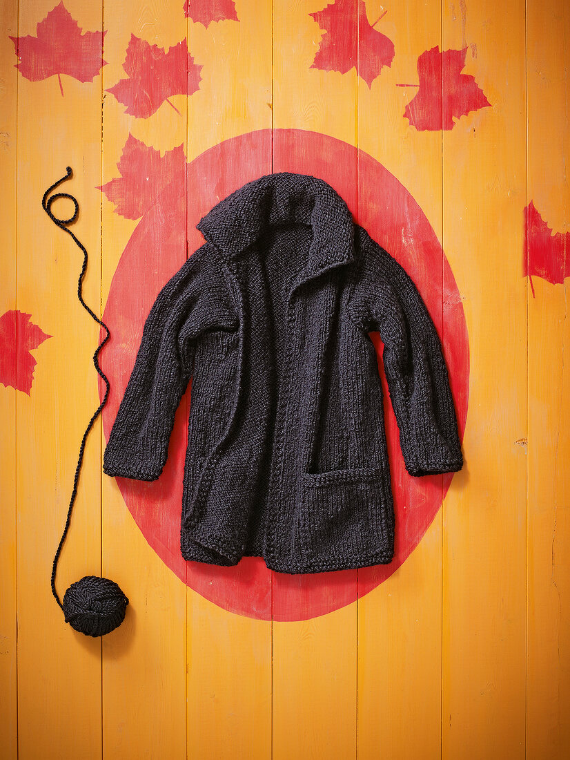 Black knitted cardigan on patterned background