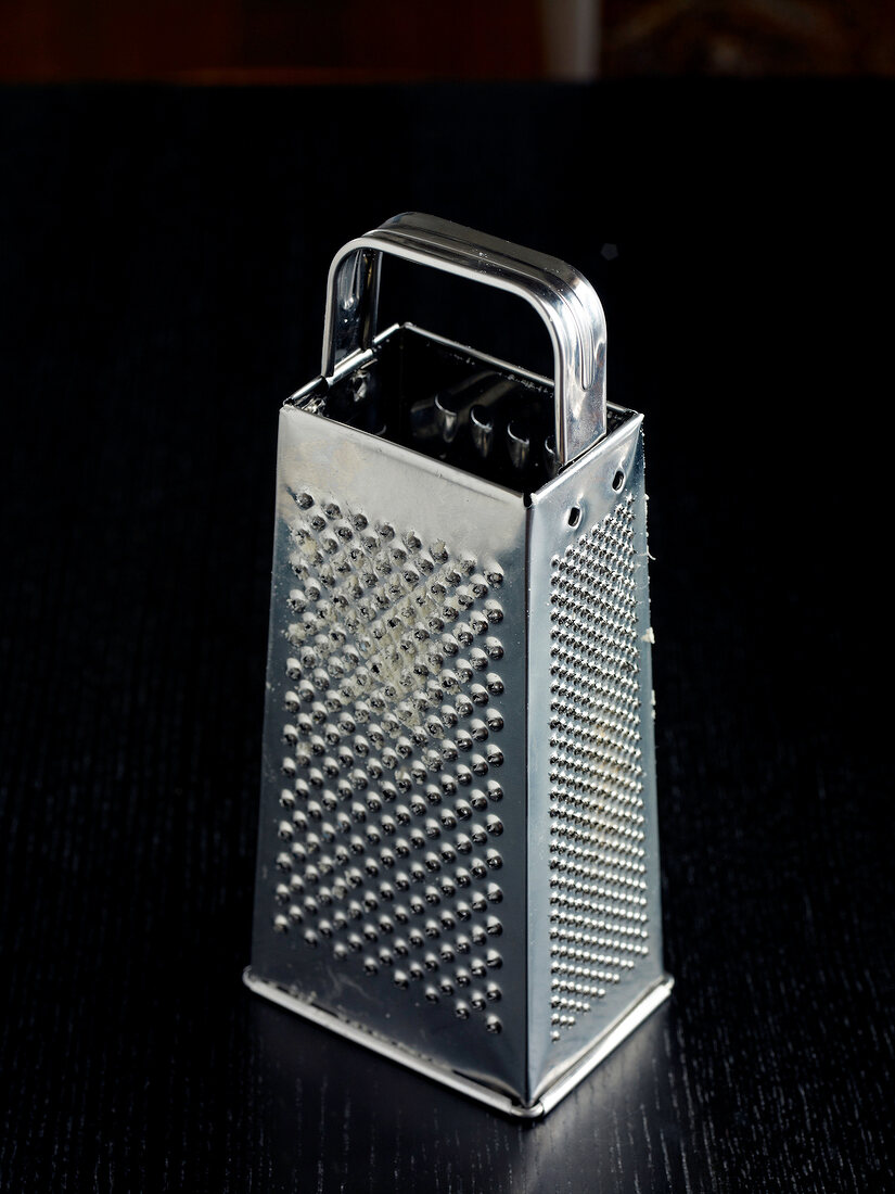 Cheese grater on black background