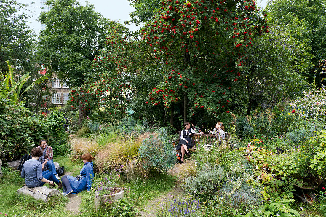 People relaxing in Phoenix Garden, London, UK