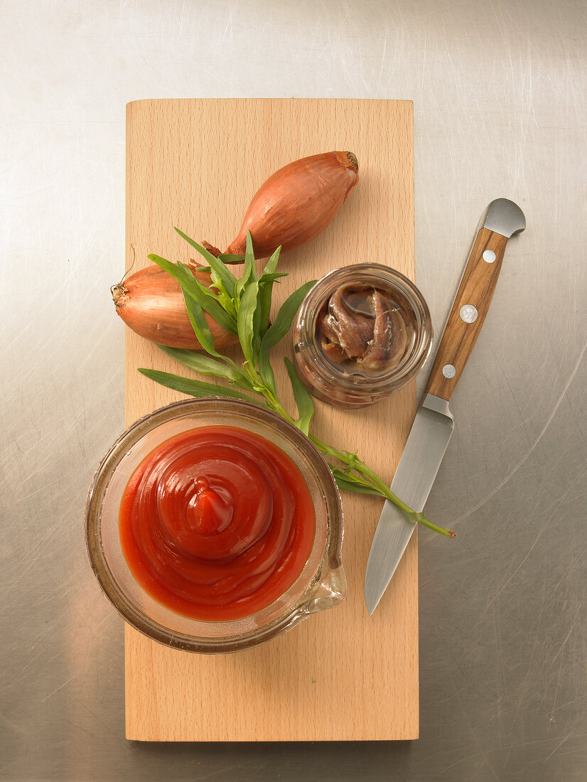 Different ingredients on chopping board for preparation of Cafe de Paris sauce