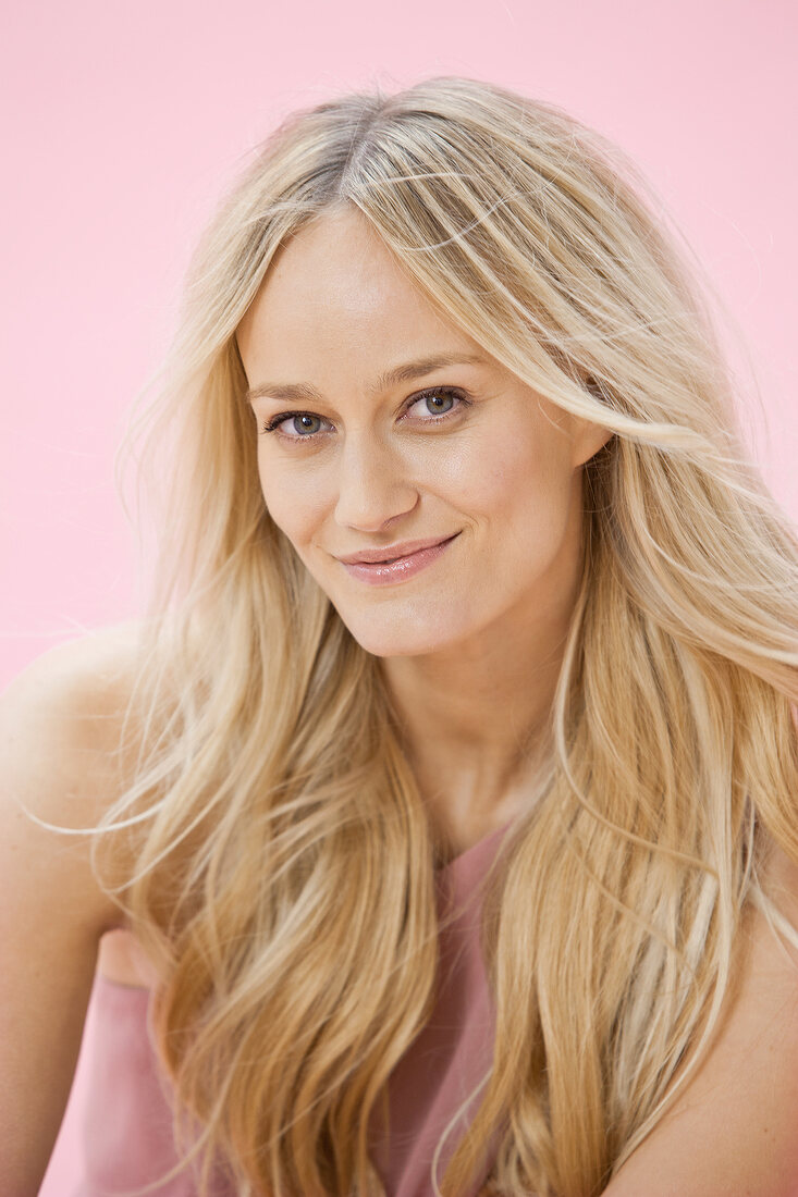 Portrait of gray eyed beautiful woman with long blonde hair, smiling