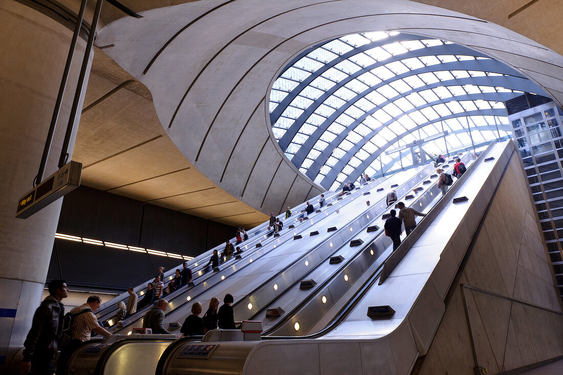 People on Tube station escalator in Canary Wharf, London, UK