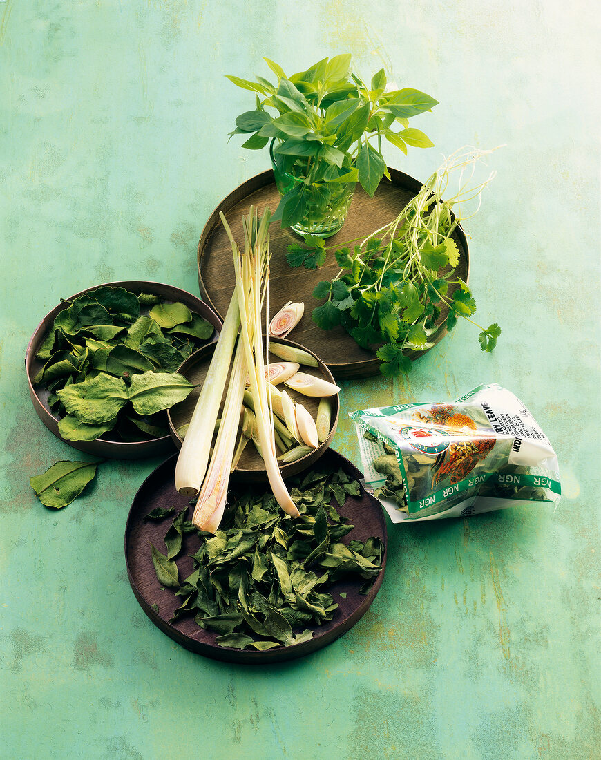 Different types of Asian herbs on plates