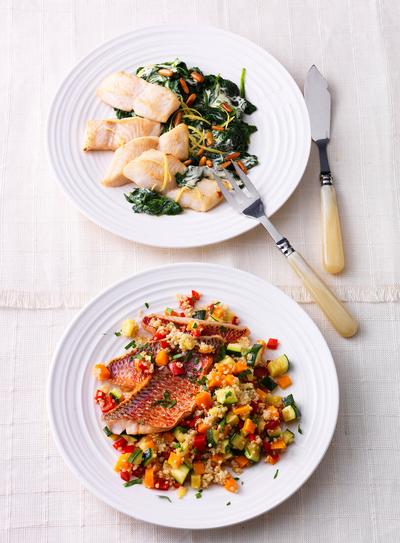 Red mullet with lemon, spinach and pangasius on plate