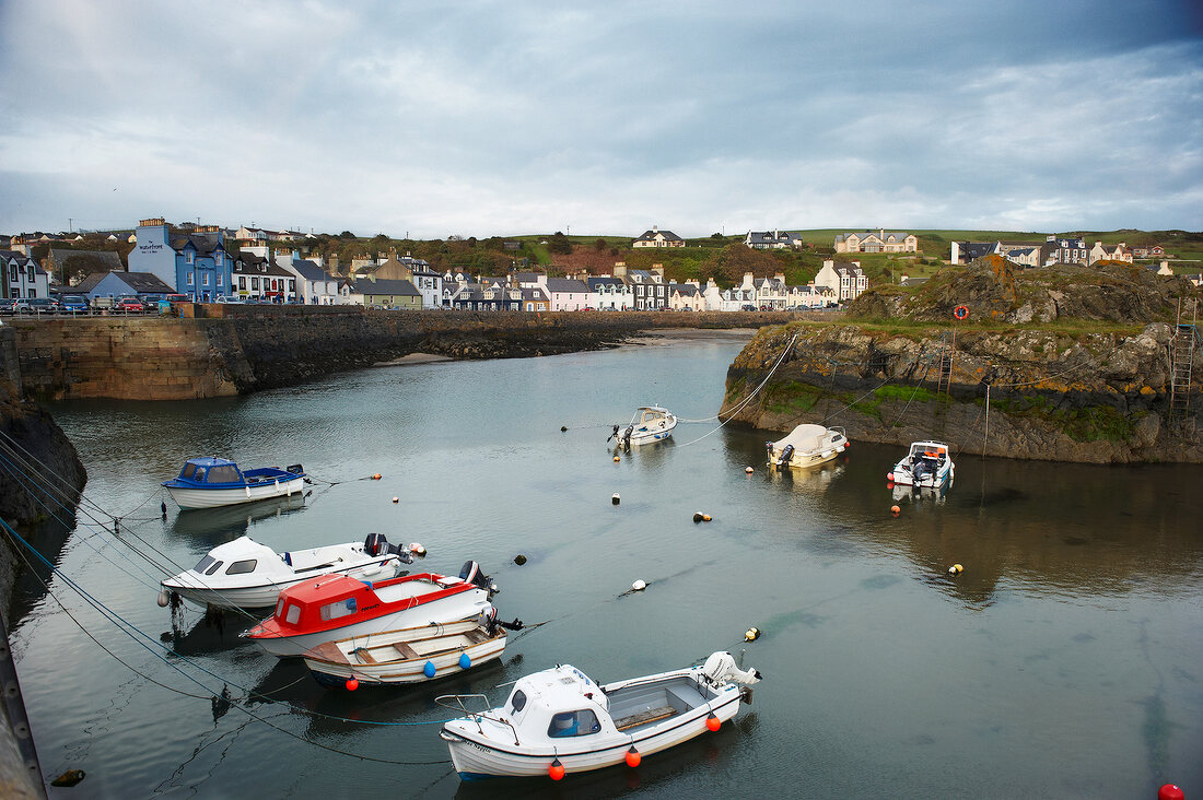 View of boats moored at harbour of Portpatrick, Scotland