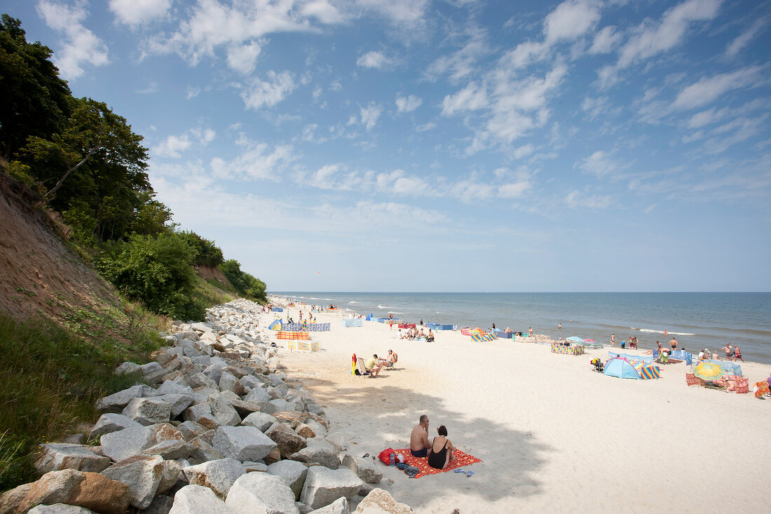 Tourists relaxing on beach of Rewal in Poland
