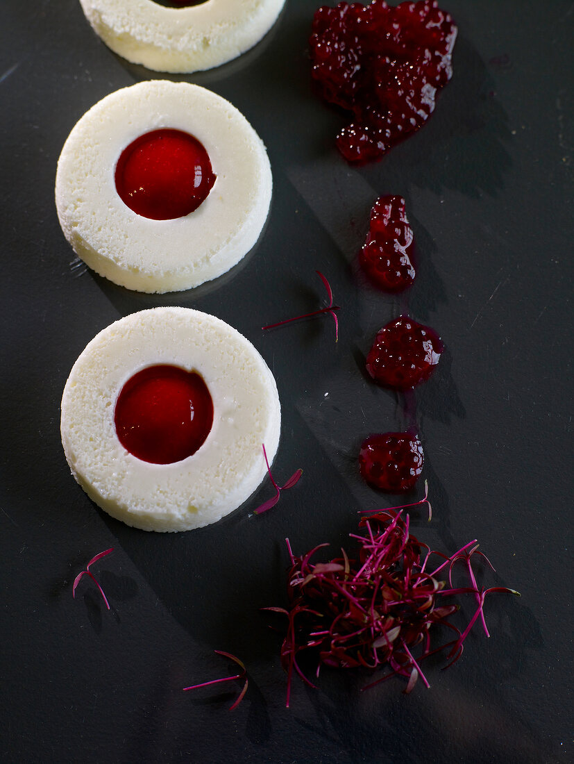 Yogurt ring with strawberry puree on black platform