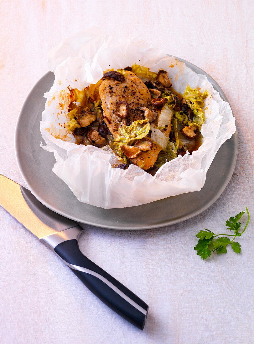 Asian chicken stew in paper on plate