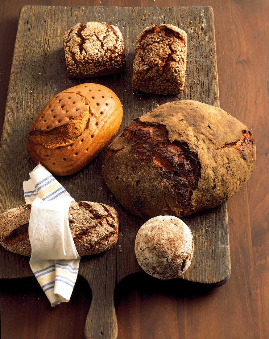Different types of breads on wooden board