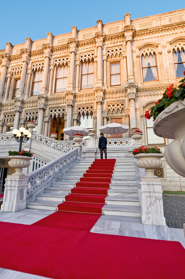 Man climbing stairway of luxury hotel at Ciragan Palace, Istanbul, Turkey