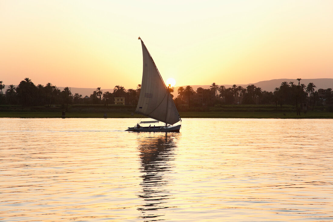People in felucca on Nile at dusk, Luxor, Egypt