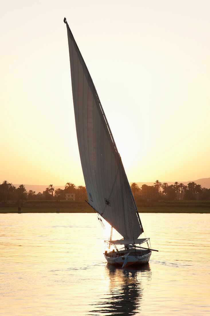 People in felucca on Nile at dusk, Luxor, Egypt