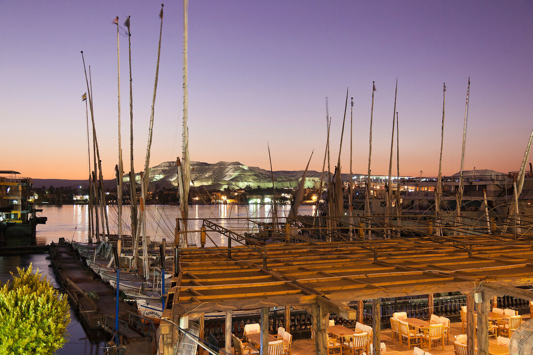 View of Nile River, boats and valley of the Kings at dusk, Luxor, Egypt