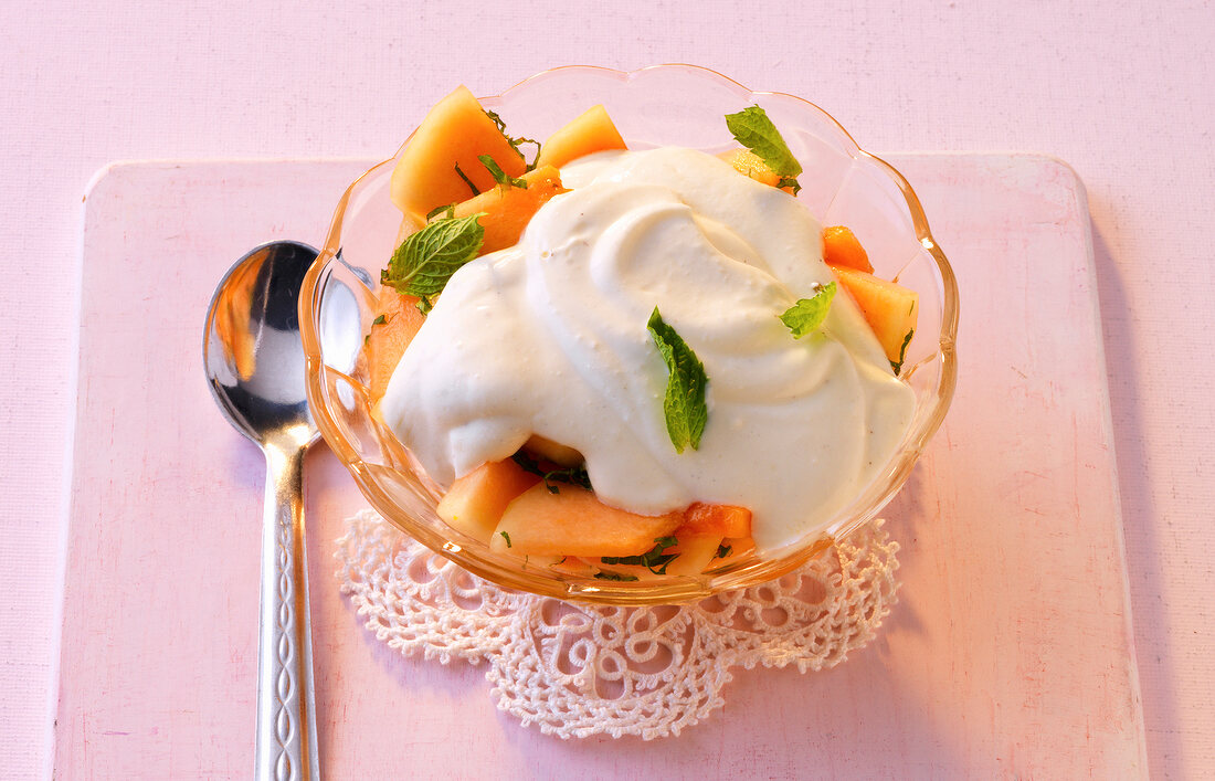 Melon salad with vanilla mascarpone cream in bowl