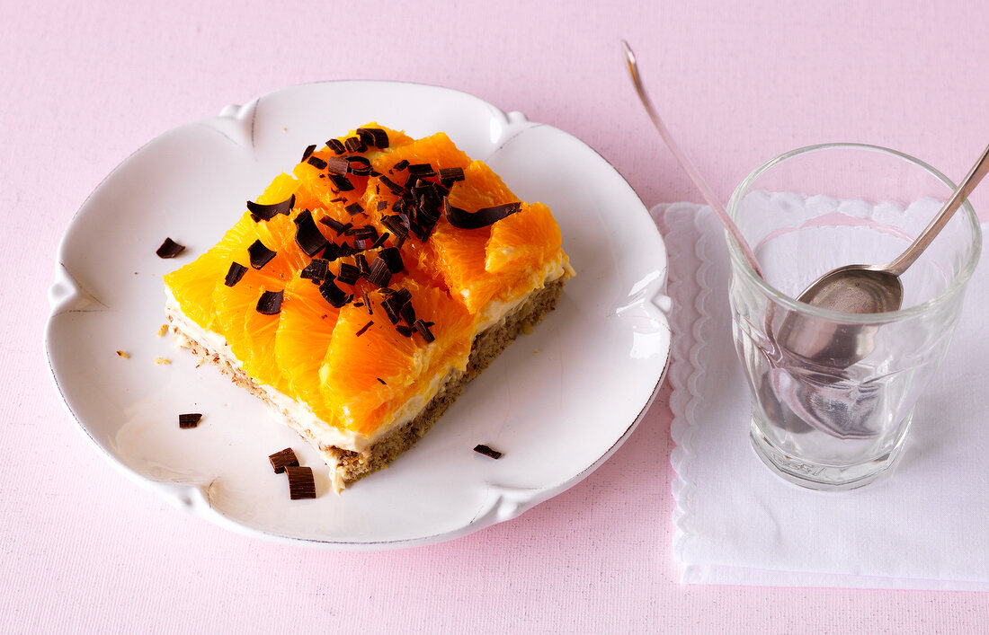 Tiramisu dessert garnished with orange on plate