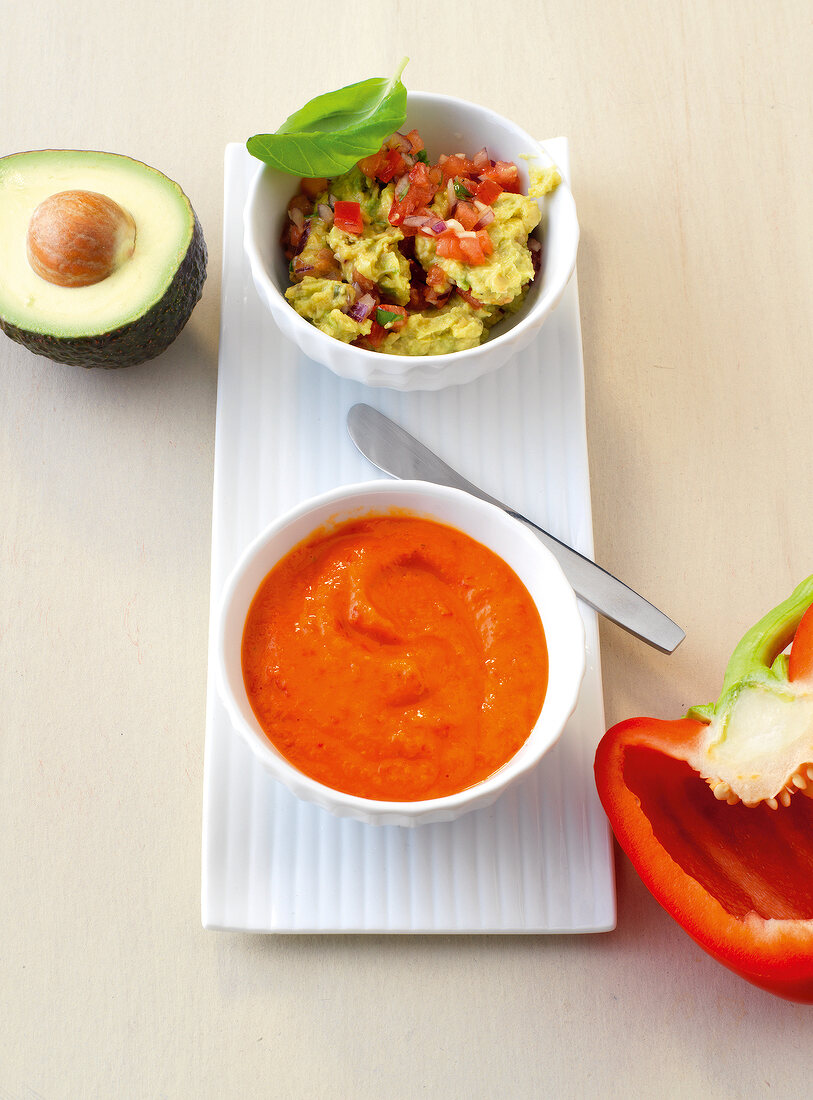 Avocado spread with red pepper dip in bowl