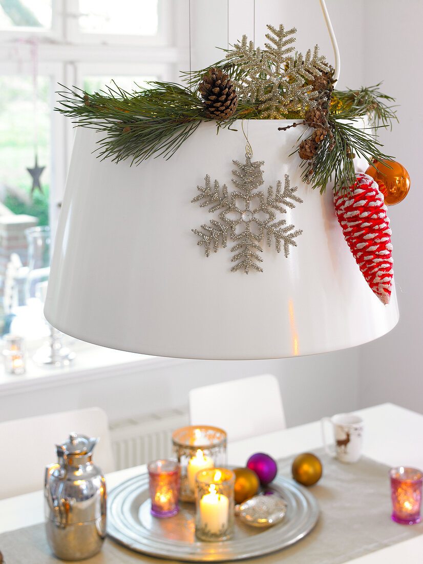 Lampshade decorated with pinecones, branches and spheres for Christmas