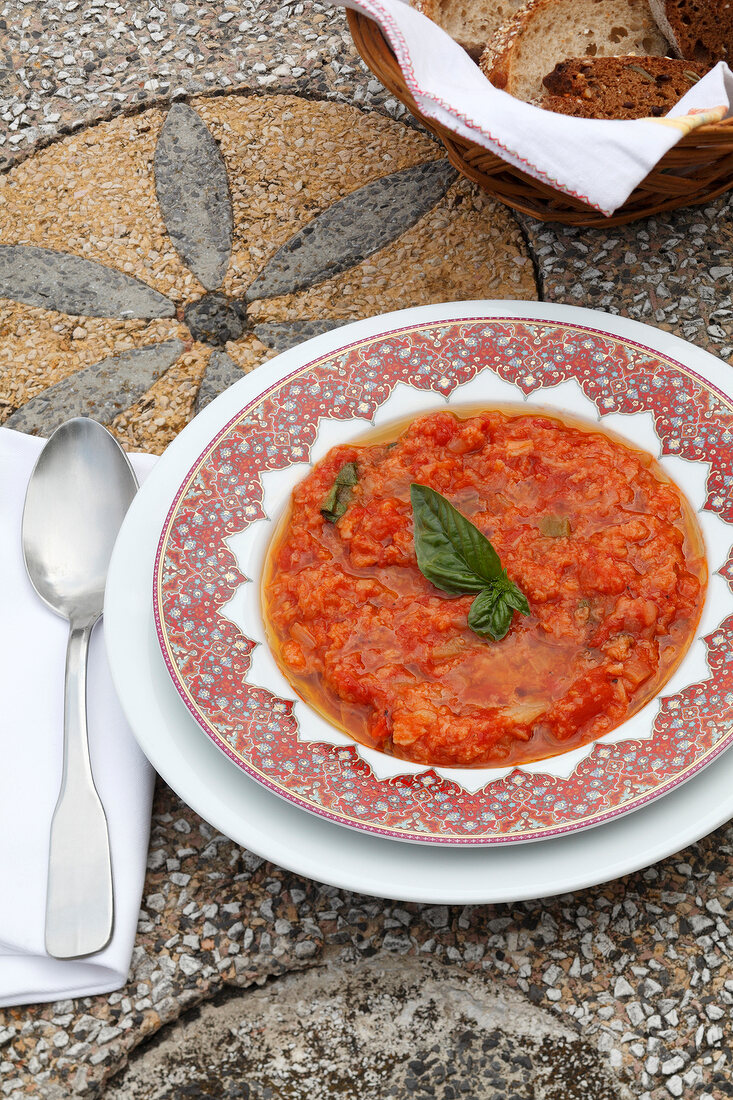 Tomato soup with herb in bowl