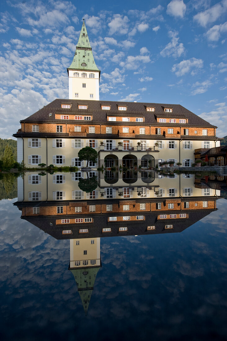 Hotel Schloss Elmau reflected in water, Upper Bavaria, Germany