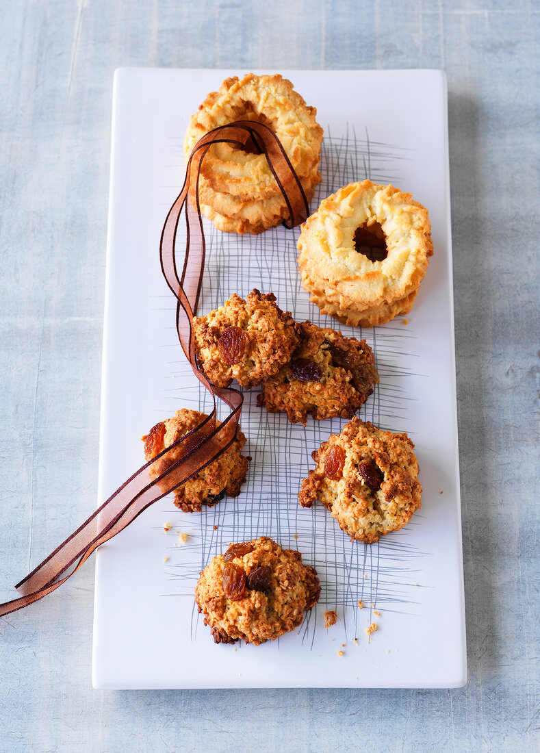 Almond rings and cereal biscuits on plate with ribbon