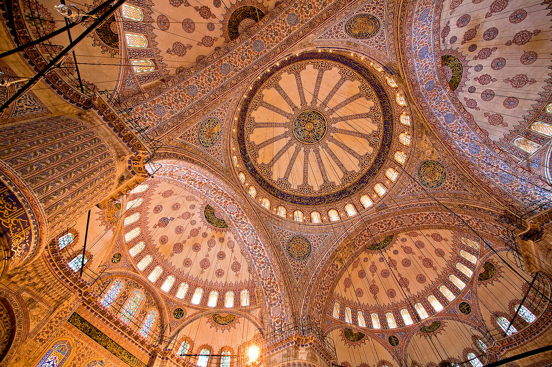 Upward view of blue mosque domes inside Sultan Ahmed Mosque, Istanbul