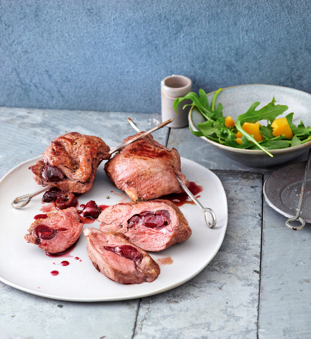 Saddle of lamb with tart cherries on a plate