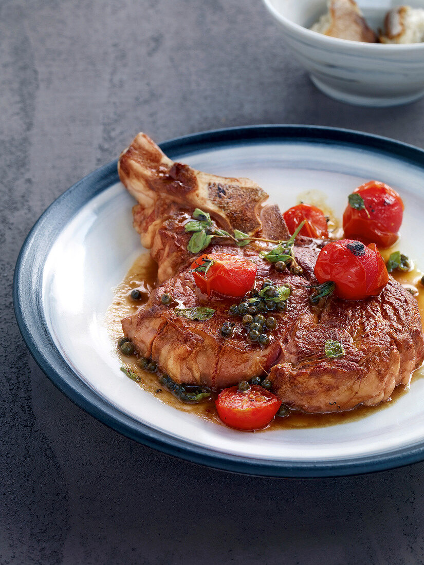 Seared ribeye Steak with pepper and tomato on plate