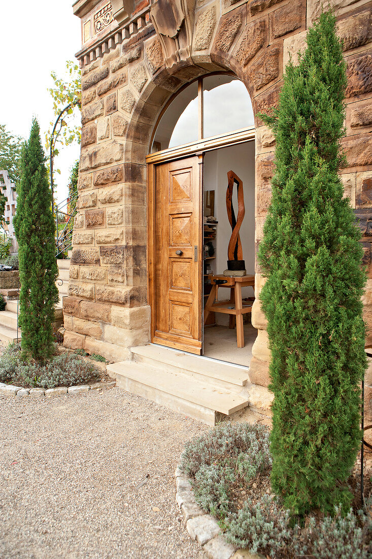 View of sculpture made of sandstone with wooden door entrance
