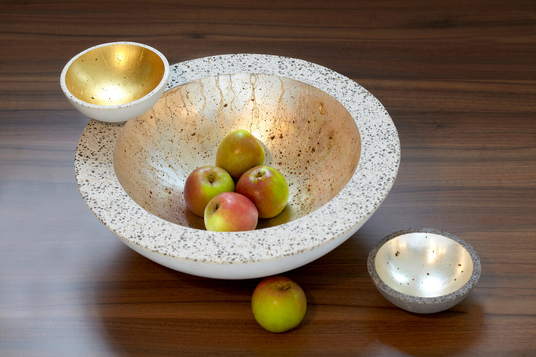 Apples in concrete bowls