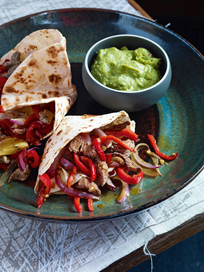 Beef fajitas with peppers and onions on plate