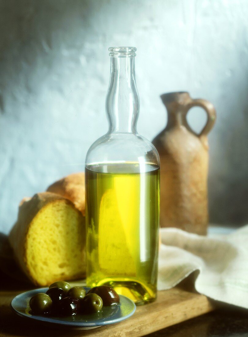 A Bottle of Olive Oil; Olives and Bread