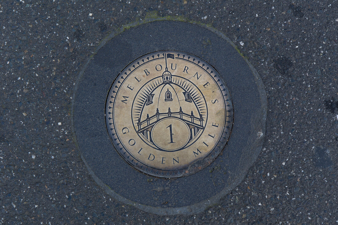 Close-up of Golden Mile plaque on ground in Melbourne, Victoria, Australia