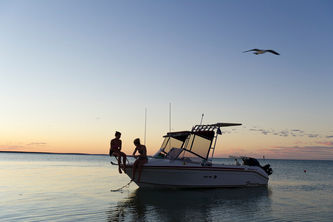 Two women sitting on boat at Monkey Mia, Shark Bay, Western Australia