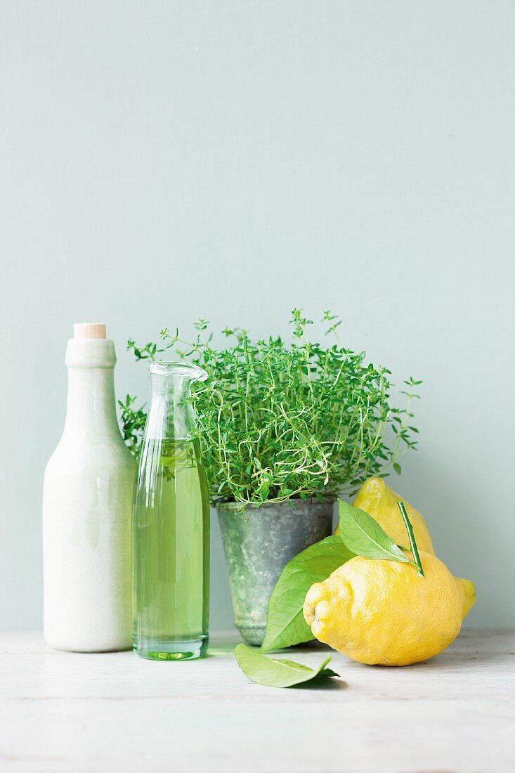 An arrangement of lemons, vinegar, oil and herbs