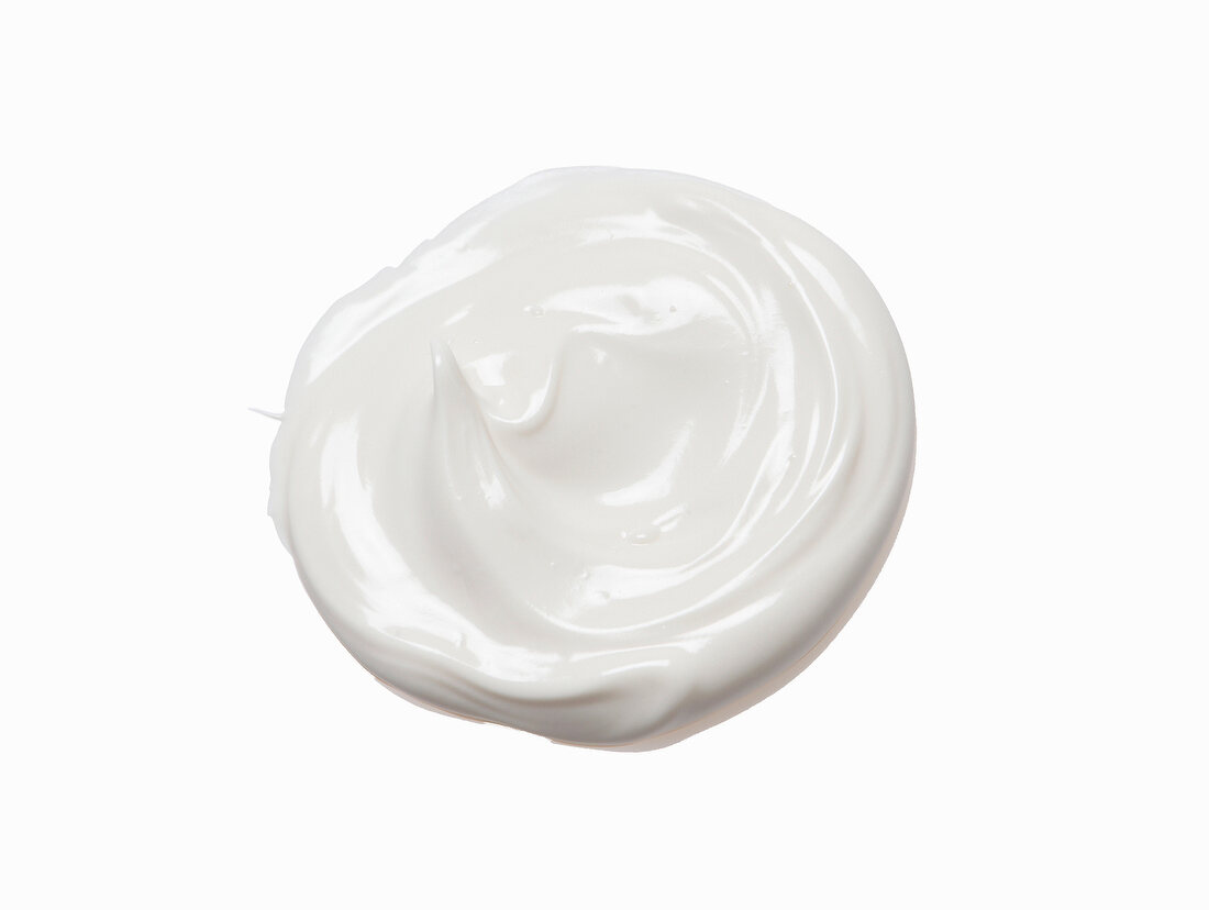 Blob of sunscreen cream on white background