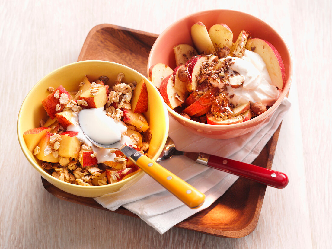 Muesli with peach, cereal and quark in bowls