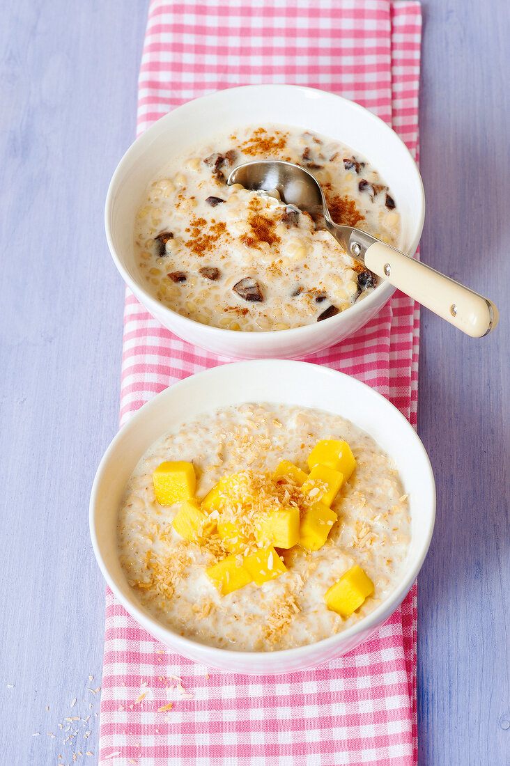 Two bowls of grains and porridge on napkin for pregnancy and lactation