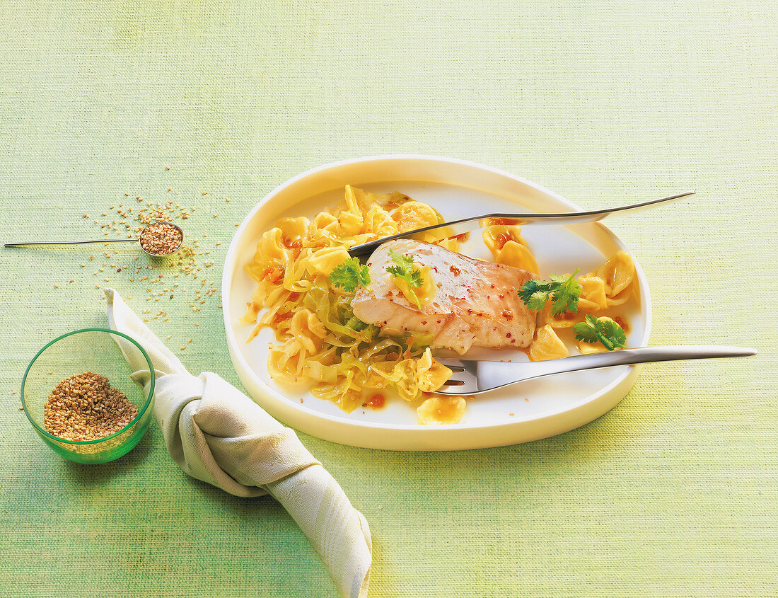 Pasta orecchiette with cod, cabbage and ginger on plate