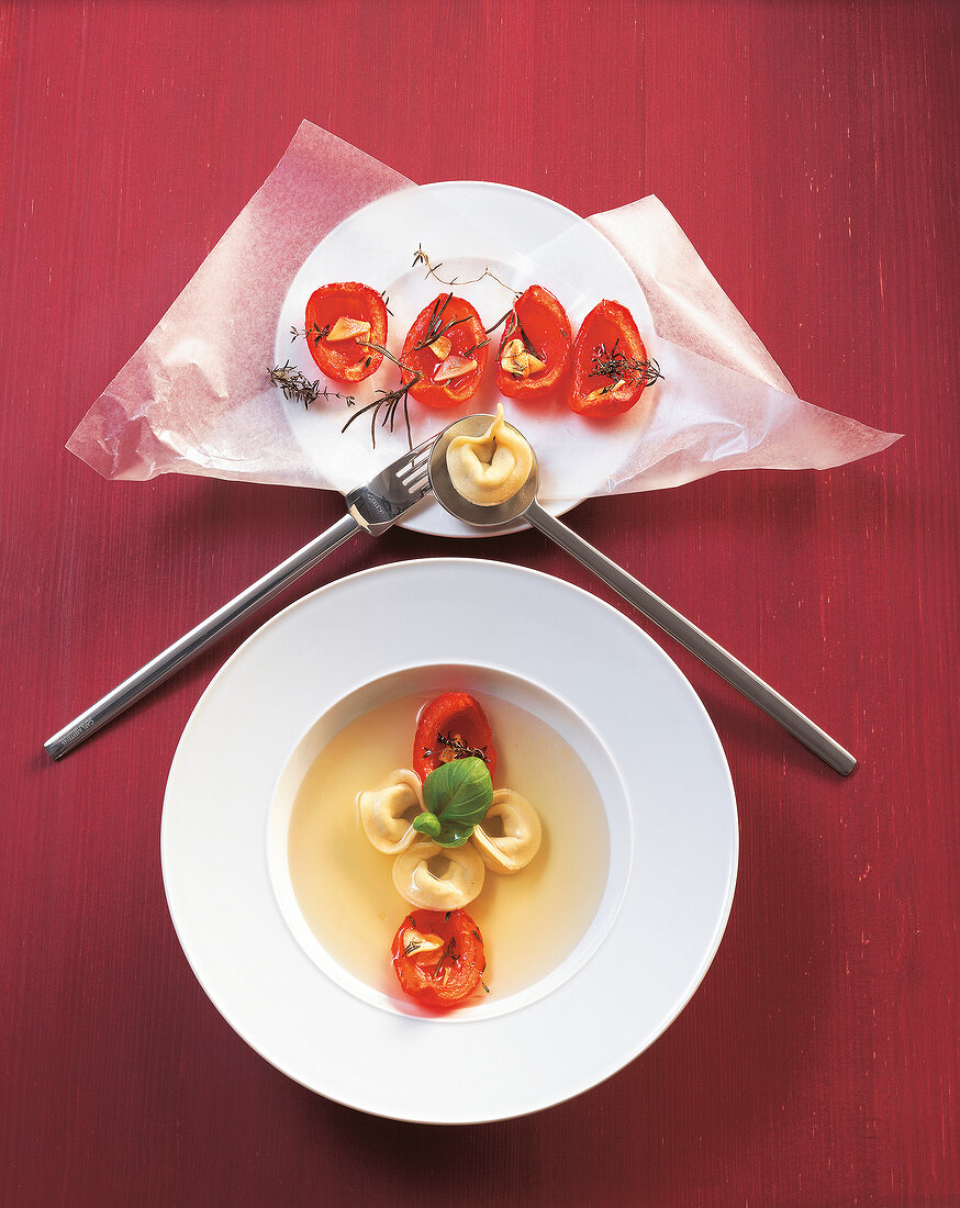 Tortellini in brodo di pomodoro and sauce on plate